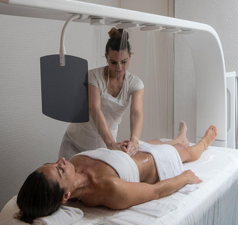 Relaxing massage under warm shower, atmosphere of wellness and tranquility.